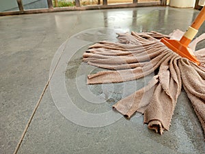 An orange microfiber strip mop