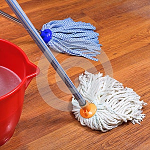 Mopping of wood floors by two mops