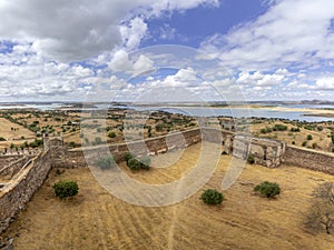 Mora medieval castle view, with Alentejo region tourist destination landscape in the background, Portugal