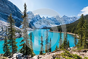 Moraine lake in autumn sunny day. Snow-capped mountains. Banff National Park, Alberta, Canada.