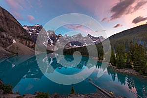 The Moraine Lake with turquoise lake and mountain reflection in sunset beautiful sky