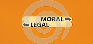 Moral or legal symbol. Concept word Moral or Legal on beautiful wooden stick. Beautiful orange table orange background. Business