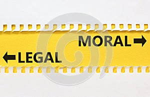 Moral or legal symbol. Concept word Moral or Legal on beautiful yellow paper. Beautiful white paper background. Business and moral