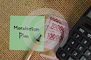 Moratorium Plan write on sticky notes isolated on Wooden Table