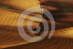 Moravian Tuscany - a tractor riding in the waves of the landscape around Kyjov in southern Moravia