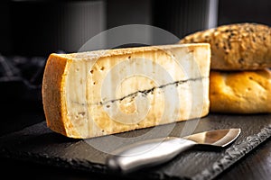 Morbier cheese. Delicious french cheese with mold on black table