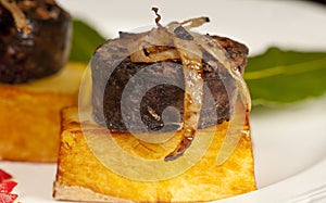 Morcilla on confit potato with onion photo