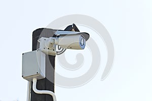 Mordern CCTV camera mounted on a pole outside a building for surveillance  purposes