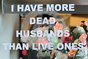 Funny sign, dead husbands photo