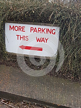 More parking this way sign.