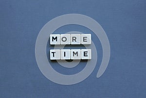 ' More Time ' word made of square letter word on grey background