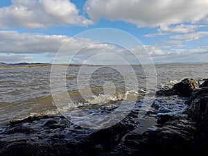 morecambe bay,high tide waves lapping on rocks