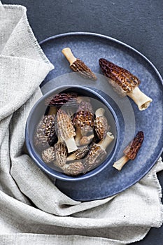 Morel mushrooms in a blue bowl