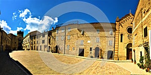 Moresco town in Fermo province, Marche region, Italy. Ancient square, church, tower and blue sky photo