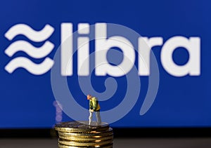 Golden coins on top of tablet computer for Libra cybercurrency