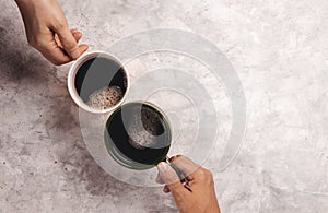 Moring Drink Concept. Couple or Two Friends holding a Cup of Coffee to making Cheers in Cafe or Restaurant . Top View photo
