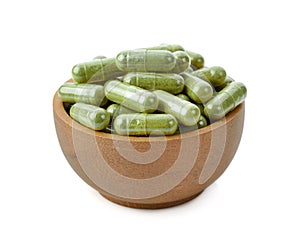 Moringa capsule pills on white photo