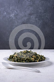 Moringa or drumstick leaves dish, tempered vegetarian dish on a table top