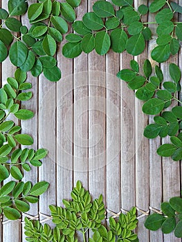 Moringa leaf with bamboo background