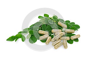 Moringa leaves with capsules isolated on white