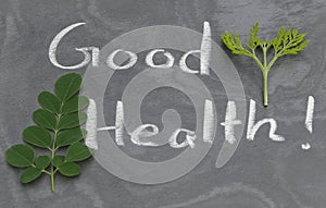 Moringa leaves with Good Health written in a slate
