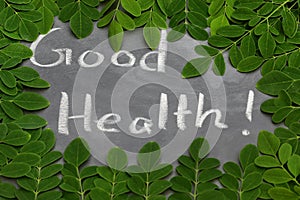 Moringa leaves with Good Health written in a slate