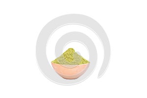 Moringa or miracle tree powder in a clay bowl isolated on a white background