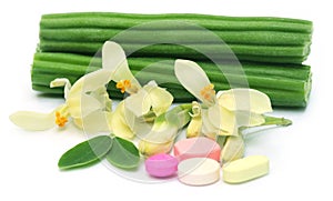 Moringa pills with flower and leaves
