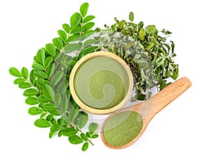 Moringa powder in wooden bowl with  fresh Moringa and dried leaves  on white background,Top view