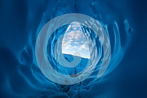 Morning in the Alaskan wilderness. Clouds seen at sunrise from inside a large blue ice cave on the Matanuska Glacier