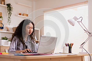 In the morning,Asian working woman on the desk with her laptop, working from home