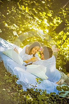 Morning on bed at nature. Young couple.