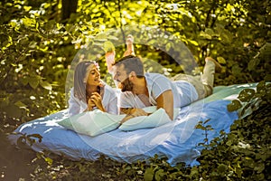 Morning on bed at nature. Young couple.