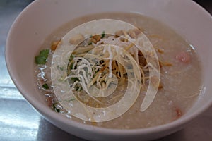 Morning Breakfast with a Chinese Cuisine Pork Congee with egg Asian rice porridge bowl