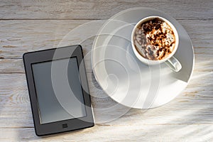 Morning breakfast with a cup of cocoa and an e-book