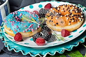 Morning breakfast with mini donuts and berries on plate under po photo
