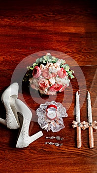 Morning of the bride. Bridal bouquet. Wedding candles in the church. Wedding rings in a red box. White shoes of the