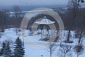 Morning in city. Pavilion in the Park VÑ–chnoj Slavi. Buildings are hiding in the fog on the left bank of the Dnipro.