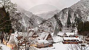 Morning clouds and mist move over Gokayama village in snowy mountain landscape