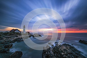 Long exposure of clouds passing over Portland Head Lighthouse in Maine