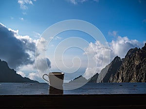 Morning coffee at the balcony of a mountain hut