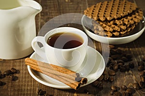 morning coffee cup with cinnamon the scattered coffee beans and cookies/morning coffee cup with cinnamon the scattered coffee