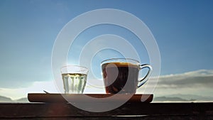 Morning coffee cup with mountain view and mist