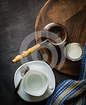 Morning coffee with marshmallows, cookies and milk. Dark wooden background.