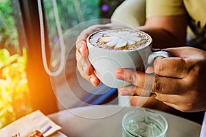 Morning coffee. Woman holds a white coffee cup