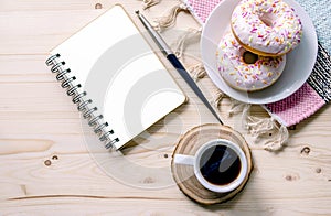 Morning composition with coffee and donuts. To-do list. Office table desk. Home office workplace.