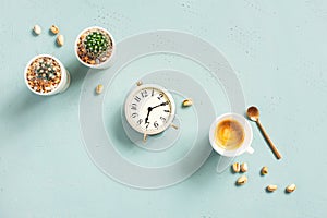 Morning composition with cup of hot coffee and clock