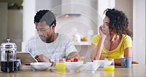 Morning, couple and tablet to ignore fight with partner at breakfast table after argument. Interracial, marriage and