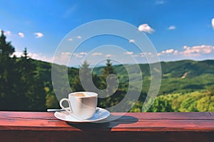 Morning cup of coffee with a beautiful mountain landscape background. Relaxation and recreation on vacation.