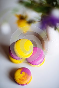 Morning cup of coffee, cake macaron, gift or present box and flower on light table from above. Beautiful breakfast. Flat lay style